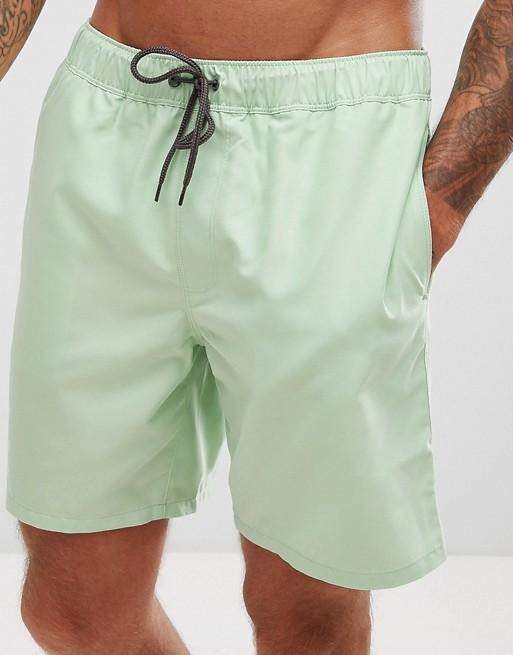 Light green swim shorts from Sky Felix, casual T-shirt style, displayed with fabric texture and elastic waistband.