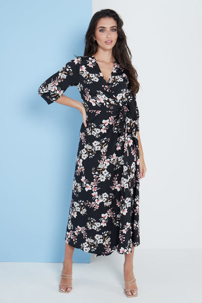Black floral print midi wrap dress for women by Amethyst Millie, featuring a fitted waist and flowing skirt.
