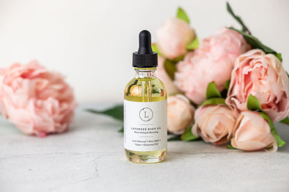 Start2Finish Lavender Body Oil bottle with natural lavender flowers, showcasing a soothing, botanical skincare product.