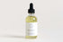 Start2Finish lavender natural body oil bottle with a clear label, placed on a white surface with soft natural lighting.