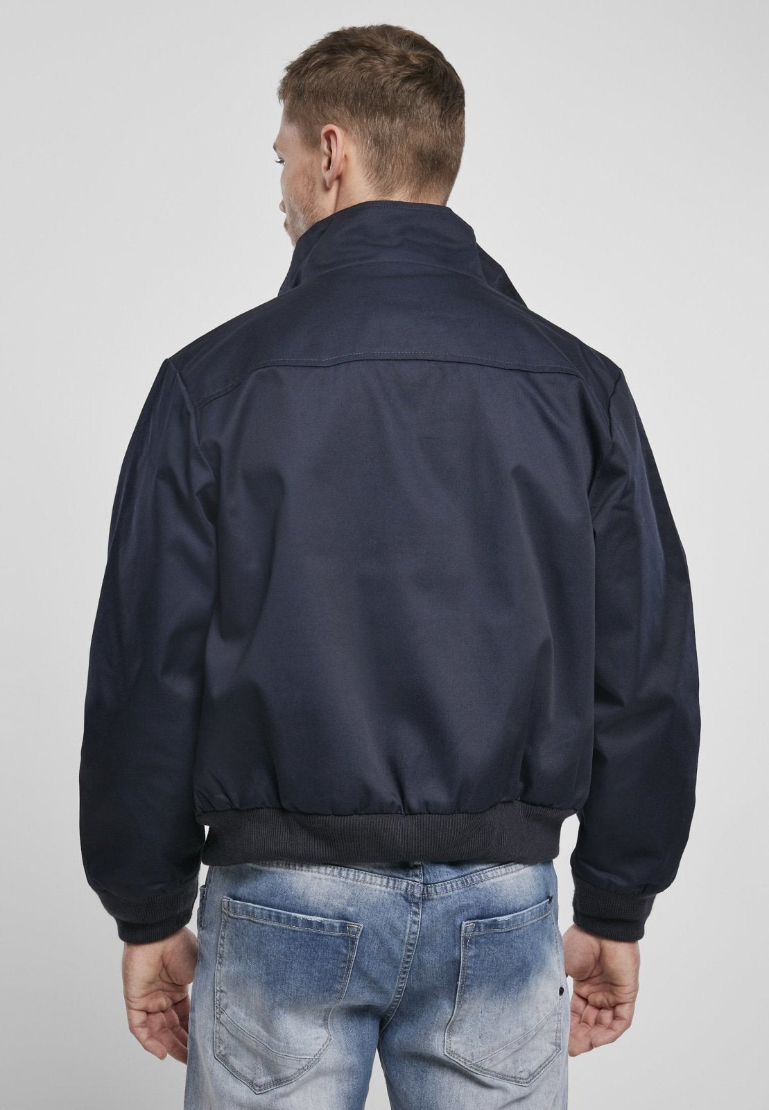 Light Norvine Harrington Canterbury jacket for men by Callisto, shown in natural outdoor setting with zipper and collar detail.