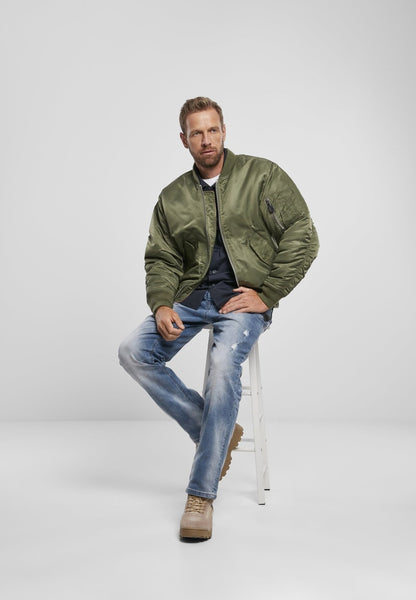 Callisto MA1 bomber jacket in olive green with ribbed cuffs and collar, displayed on a hanger.