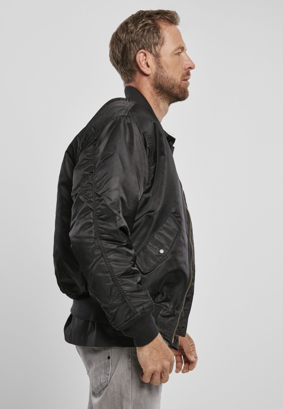 Black Callisto MA1 bomber jacket with ribbed cuffs and collar, featuring front zipper pockets and a sleek, modern design.