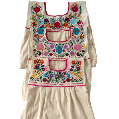 White Maxi Isidra Mexican embroidered dress for women by Violet Athena, featuring intricate colorful embroidery and flowing fabric.