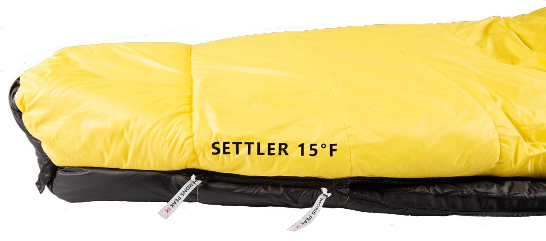 Triangulum Settler 15F sleeping bag for camping, shown with zipper and insulated interior, ideal for outdoor sleeping comfort.