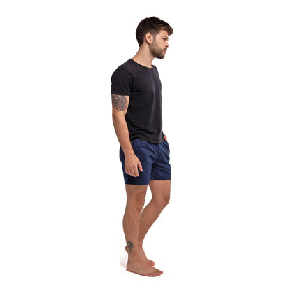 Navy cotton swim shorts by Ruby Tartarus with a relaxed fit, shown on a model against a neutral background.