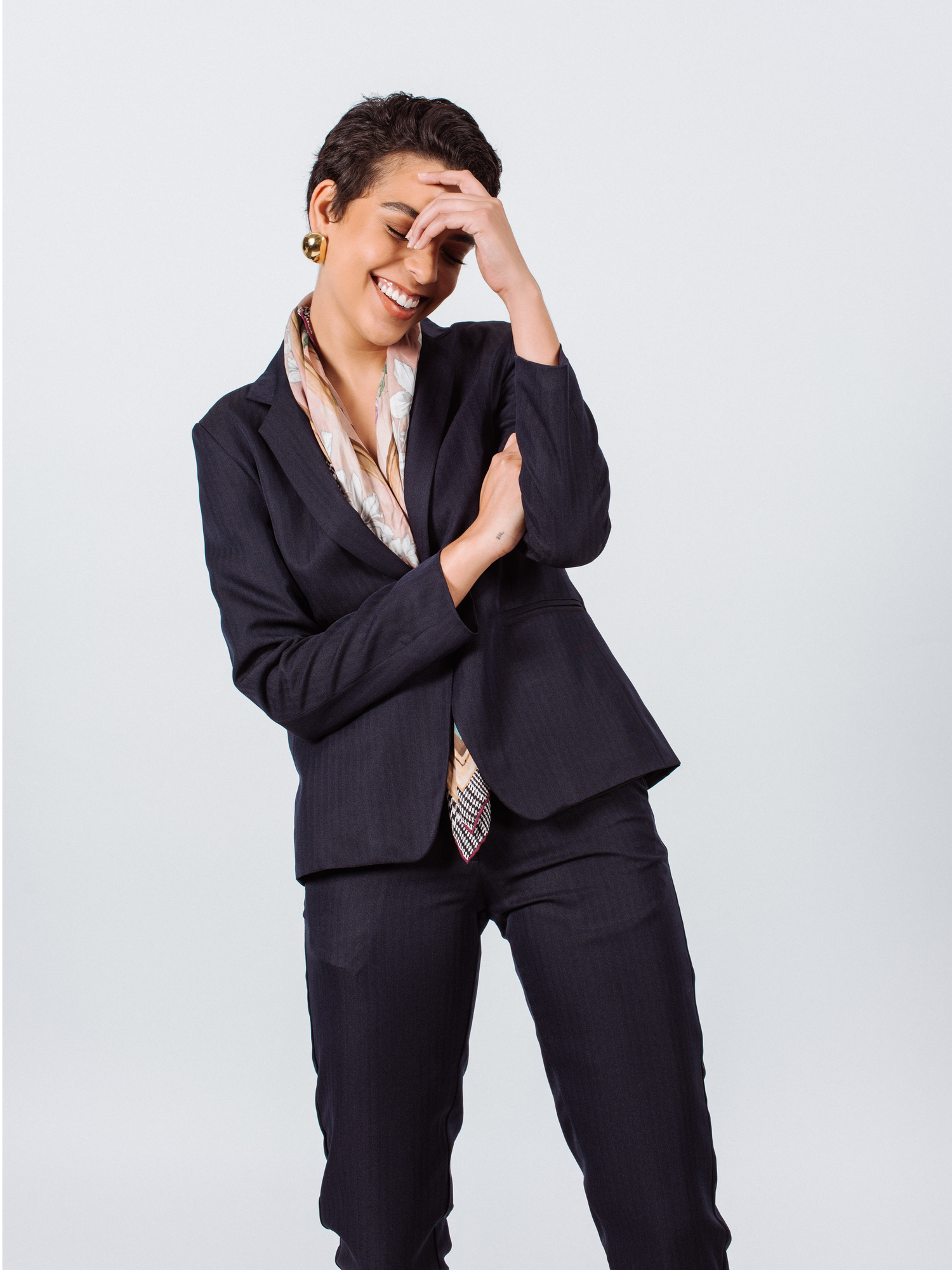 Navy peak-lapels single-breasted tailored blazer for women by Mauve Daisy, shown on a hanger.