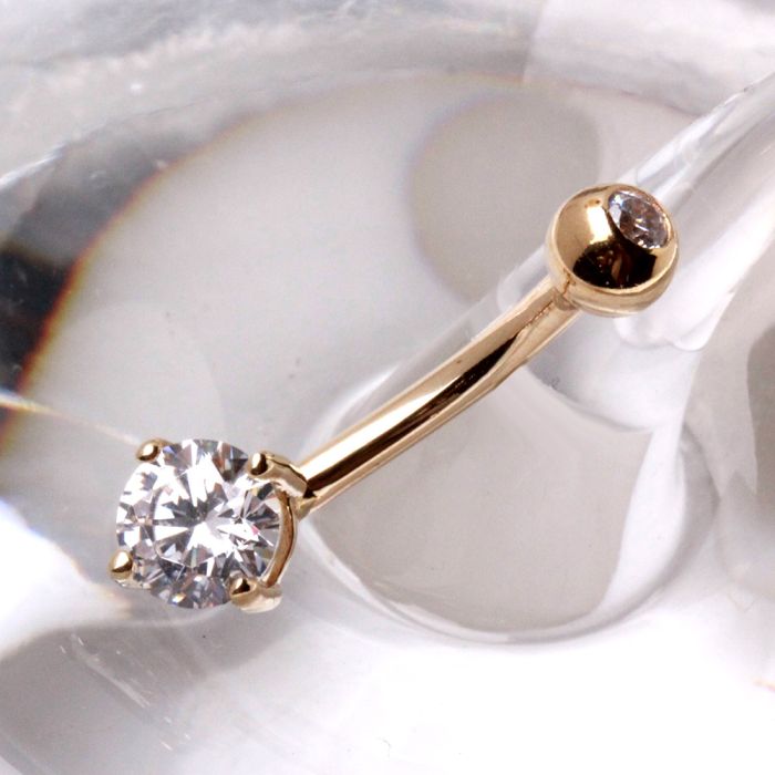 14K gold navel ring with prong-set round cubic zirconia, stylish jewelry by Peridot, shown in close-up image