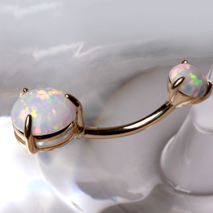 14K yellow gold navel ring with prong set white synthetic opal, jewelry and watch accessory with a sleek, polished design.