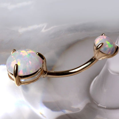 14K yellow gold navel ring with prong set white synthetic opal, jewelry and watch accessory with a sleek, polished design.