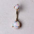 14K yellow gold navel ring with prong-set white synthetic opal, jewelry and watch accessory featuring a polished gold finish.