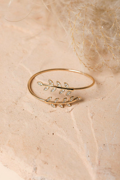 Gold olive branch minimal bracelet from Periwinkle Aether, featuring delicate leaf design, perfect as stylish accessories.