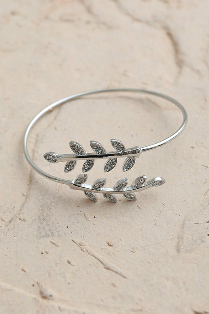Silver Olive Branch Minimal Bracelet by Periwinkle Aether featuring a delicate olive branch design in a sleek, minimalist style.