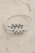Silver Olive Branch Minimal Bracelet by Periwinkle Aether featuring a delicate olive branch design in a sleek, minimalist style.