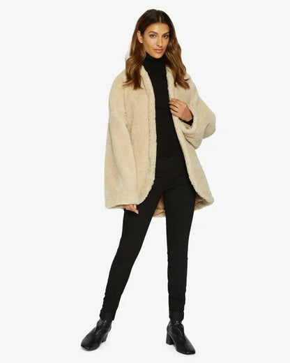 Beige Rose Eleusis open-front belted teddy coat with cozy collar and pockets, stylishly displayed on a hanger.