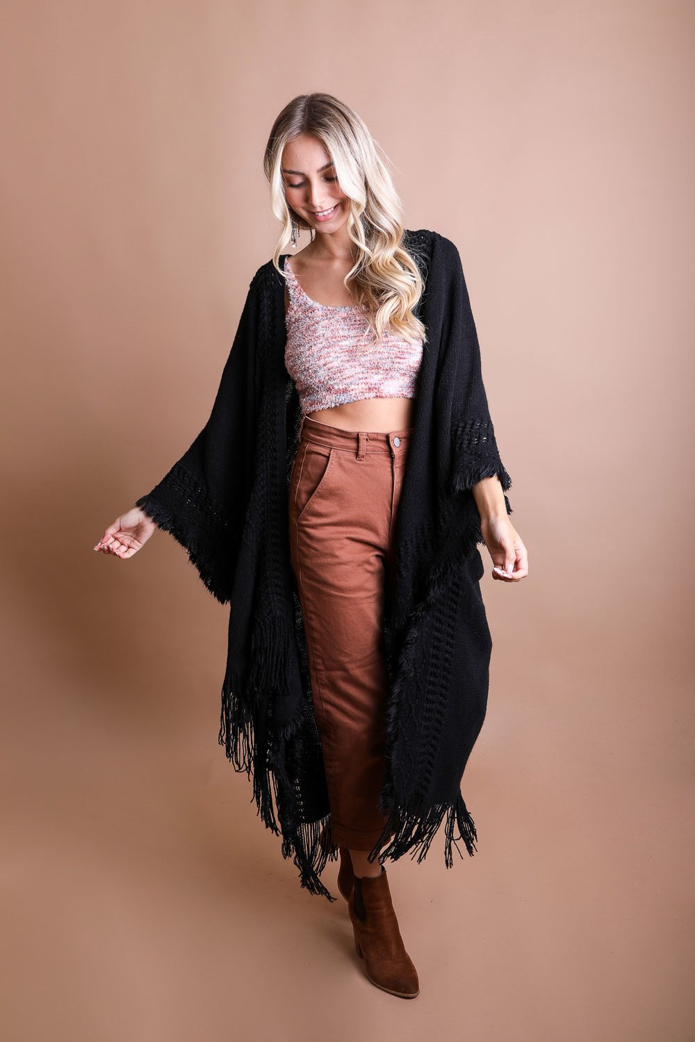 Open work frayed bohemian ruana in black, stylish accessory by Periwinkle Aether, featuring open-knit design and frayed edges.