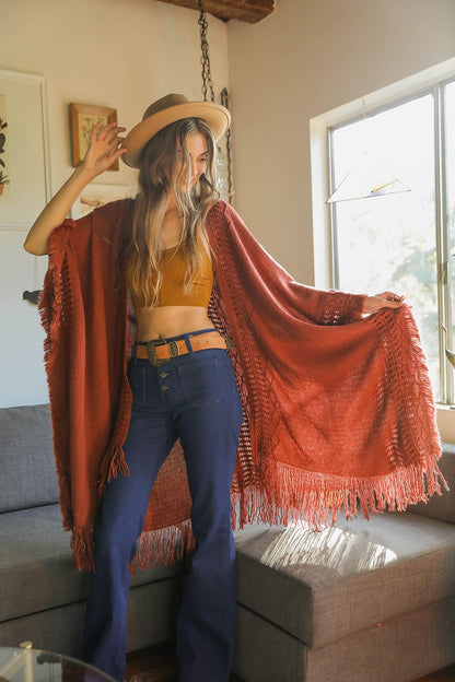 Open work frayed bohemian ruana in burnt henna color, casual accessories by Periwinkle Aether with open-knit design and fringe details.