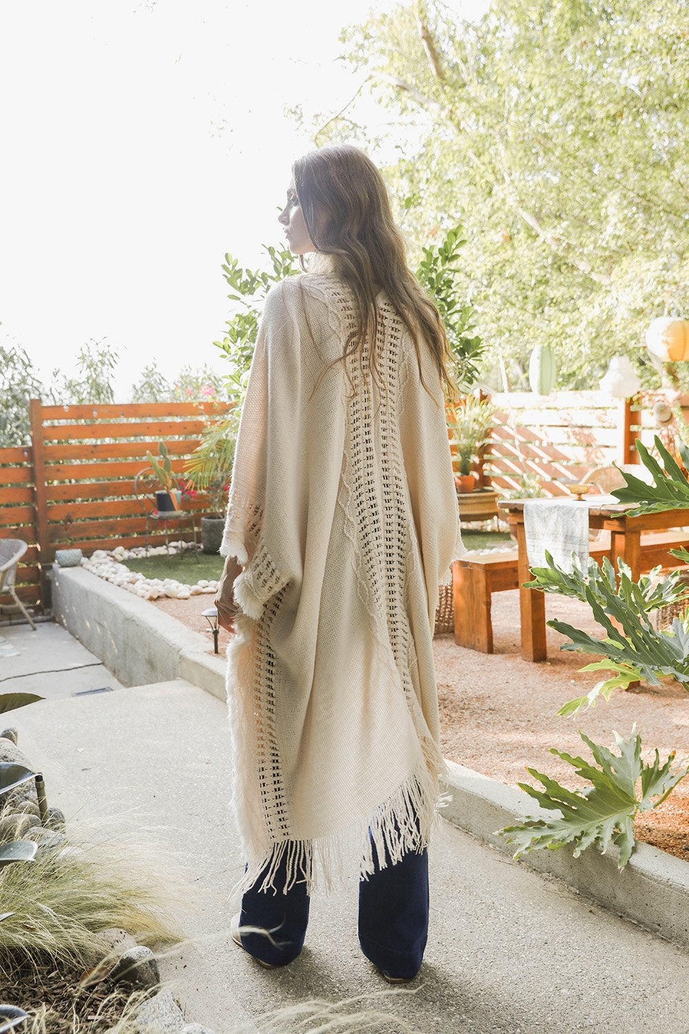 Open work frayed bohemian ruana by Periwinkle Aether, featuring lightweight fabric with a relaxed, open design and fringe details.