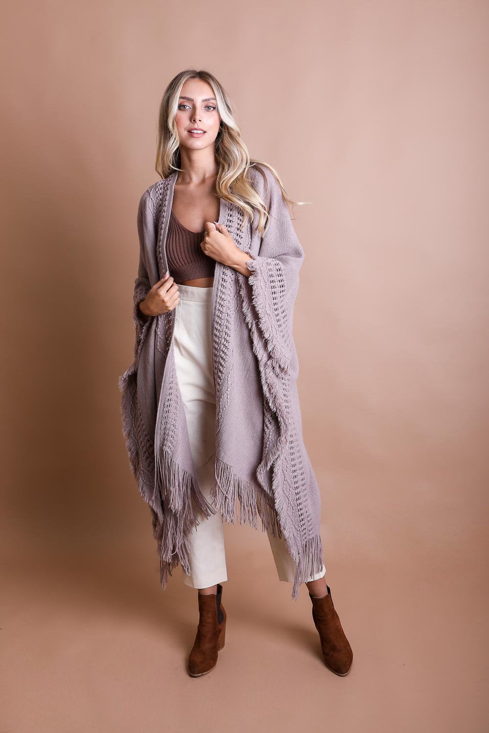 Gray open-work frayed bohemian ruana by Periwinkle Aether, styled as a lightweight, fringed wrap for boho accessories.