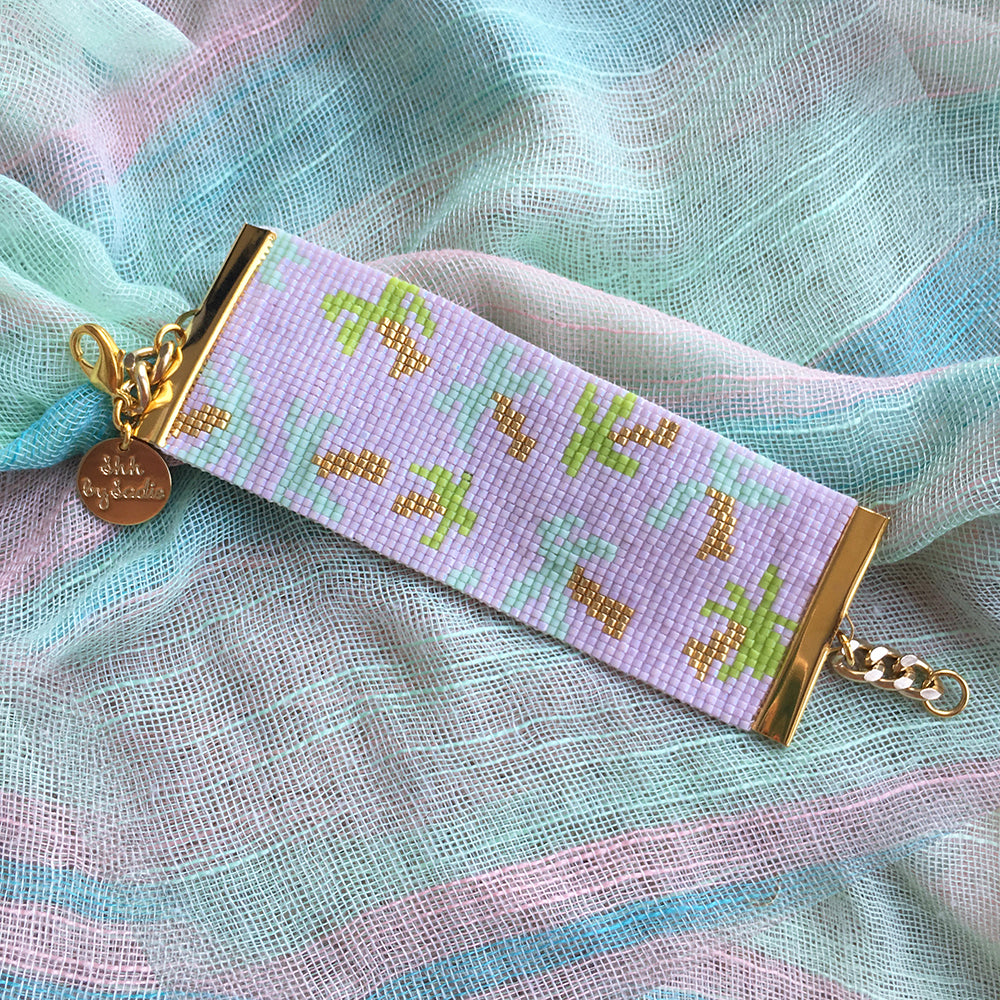 Golden Palms bracelet by Yellow Athena featuring a stylish bracelet with palm leaf design and gold-tone finish.