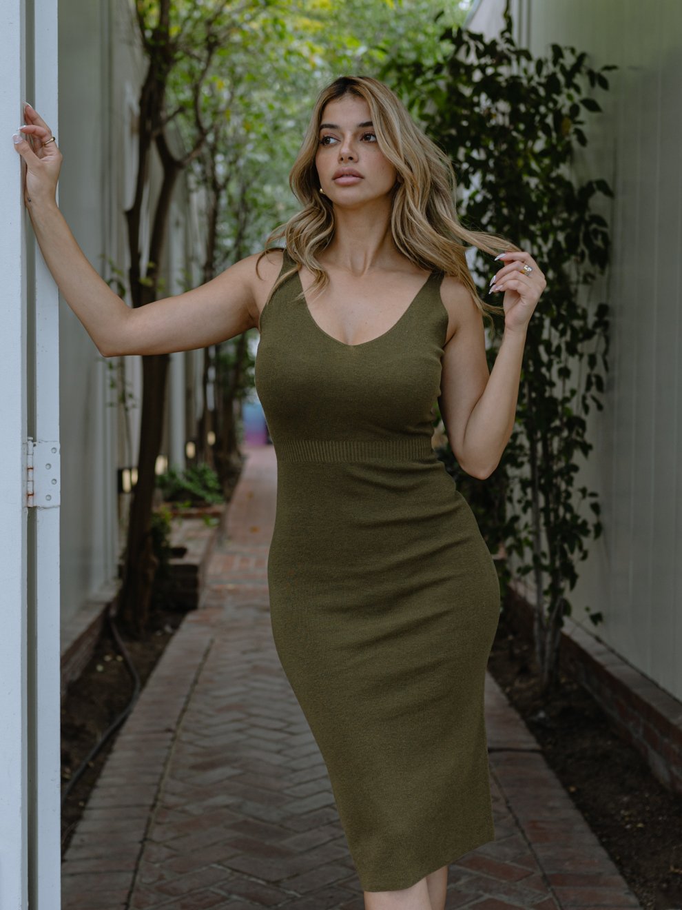 Azure Thanatos Uptown Knit Midi Dress displayed on a model, featuring a fitted silhouette, long sleeves, and a ribbed knit texture.