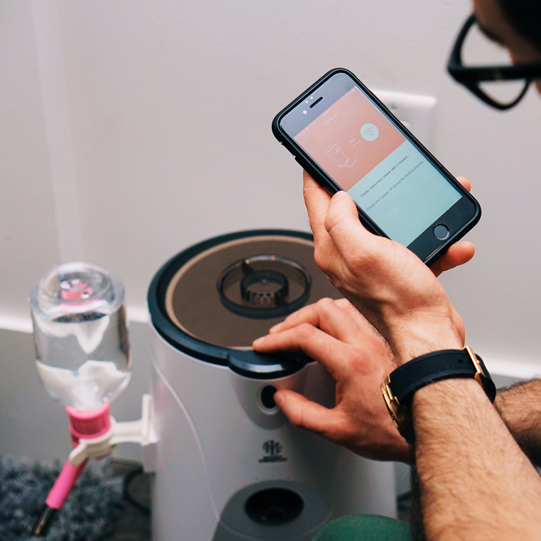 Pink Trillium WiFi Pet Feeder for petcare, showing a sleek device with food compartments and WiFi connectivity.