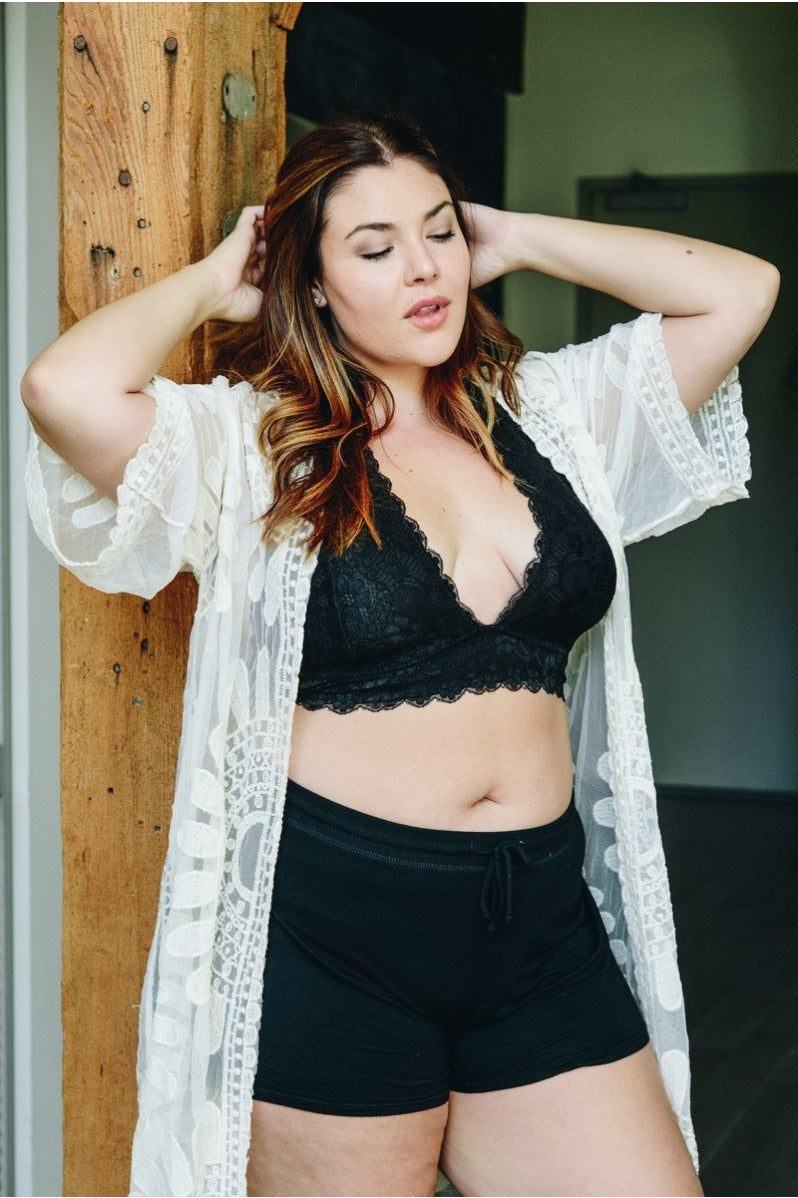 Plus black halter top bralette from Periwinkle Aether, featuring soft fabric and stylish design, shown on a hanger.