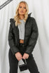 Black PU Boxy Puffer Jacket by Rose Eleusis, showcasing a stylish, cropped puffer coat with a quilted design and stand-up collar.