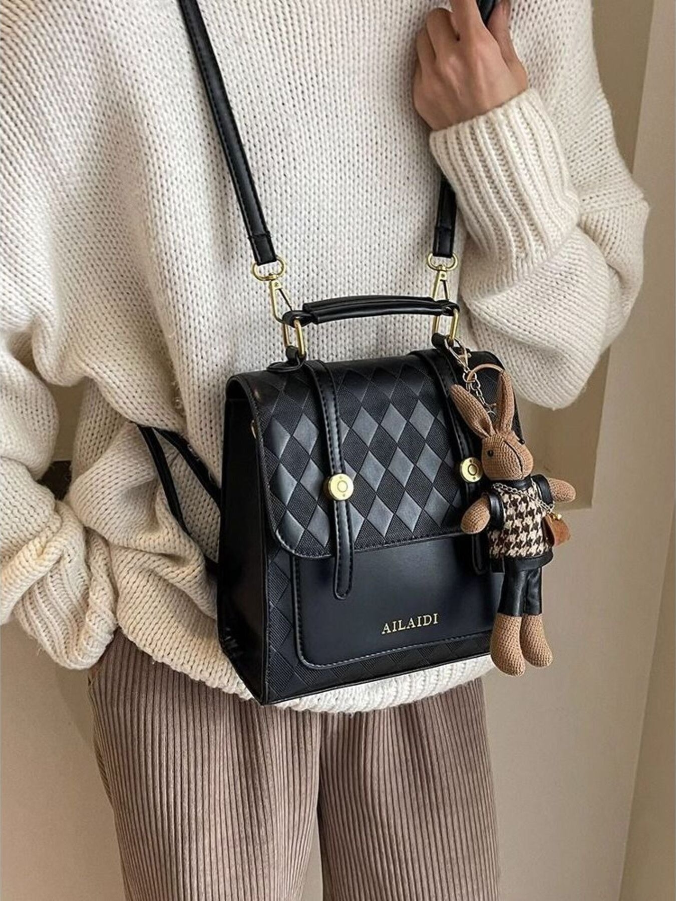 Taupe Gaia quilted flap backpack bag for women, featuring a stylish, padded design with a front flap and adjustable straps.