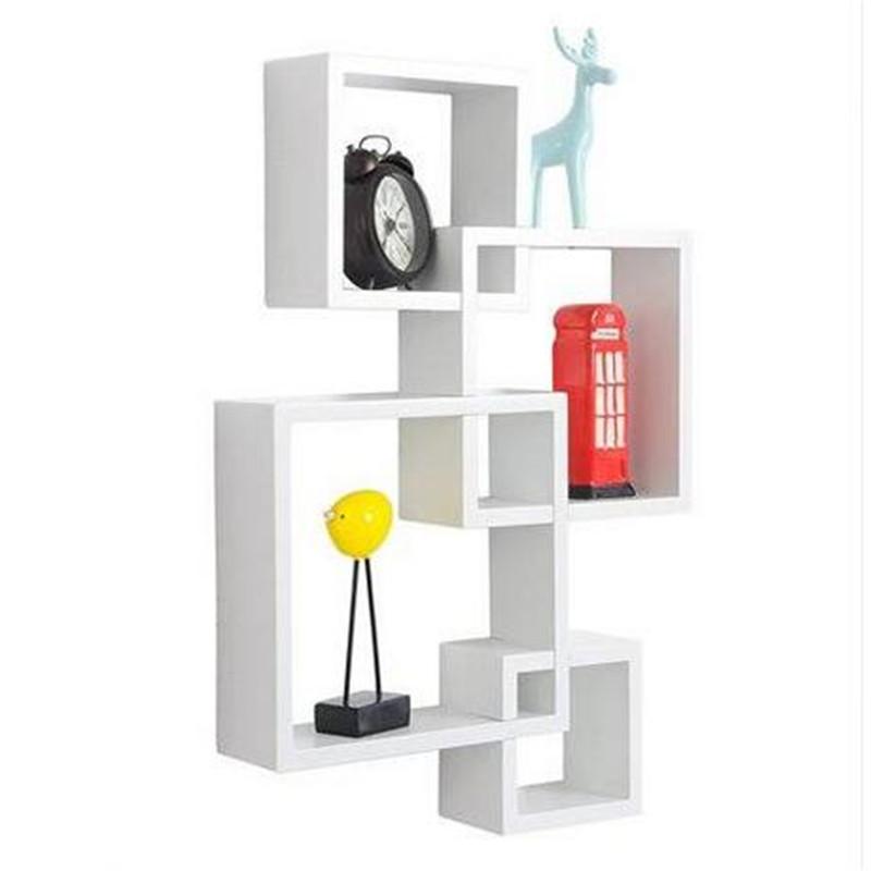 Set of four Blue Charlie floating wall shelves with intersecting modern design for decorative storage in home and garden spaces.