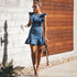 Blue Charlie Songsanding denim mini sundress with backless design, perfect for summer, displayed on a hanger.