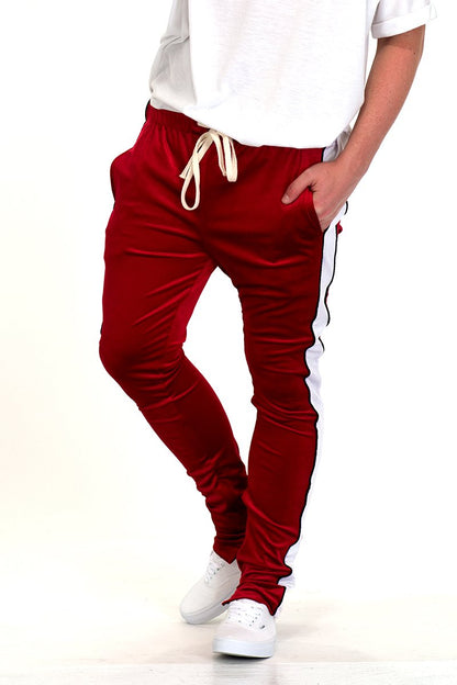 Lime Milo velvet pants with side stripe, piped design, ankle zippers, and jogger style, shown on a model.