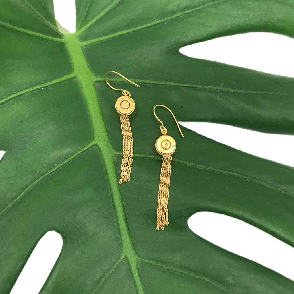 Ariel bullet tassel earrings featuring recycled bullet metal and colorful tassels hanging from silver hooks.