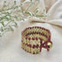 Ariel Riya Cuff Bracelet in bold red and gold, featuring a statement design with intricate detailing.