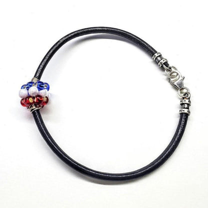 Red, white, and blue beaded leather bracelet by Blue Crius featuring patriotic-style beads and adjustable strap.