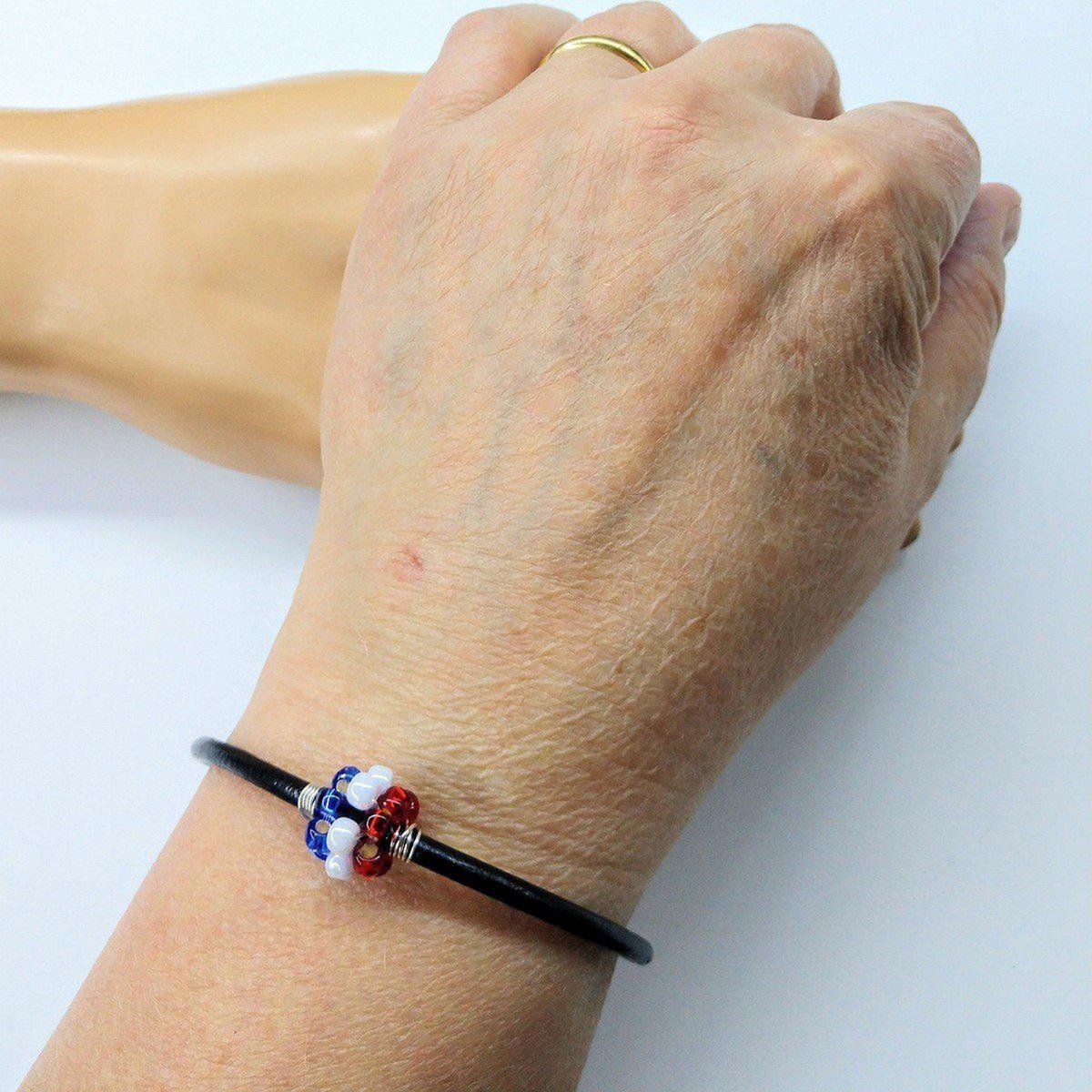 Red, white, and blue beaded leather bracelet from Blue Crius, featuring patriotic design and adjustable fit.