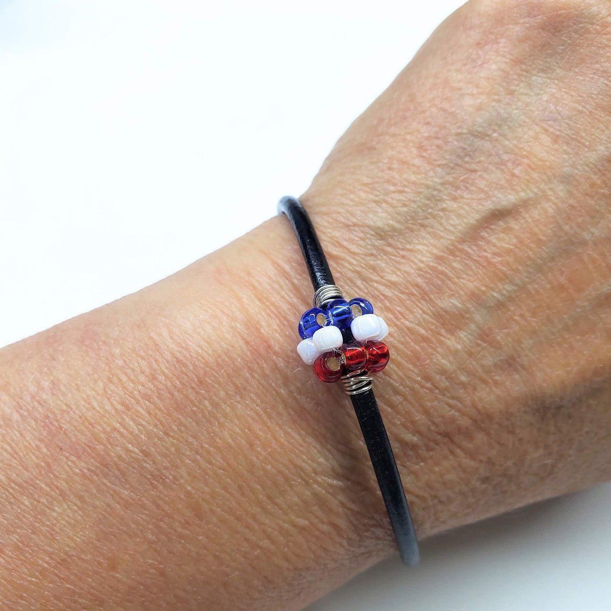 Red, white, and blue beaded leather bracelet by Blue Crius, featuring patriotic design and adjustable clasp.