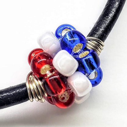 Red, white, and blue beaded leather bracelet by Blue Crius, featuring patriotic design and adjustable closure.