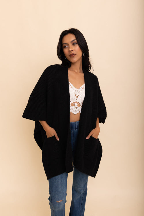 Black boucle cardigan by Periwinkle Aether, cozy and stylish accessory with a relaxed fit, perfect for autumn nights.