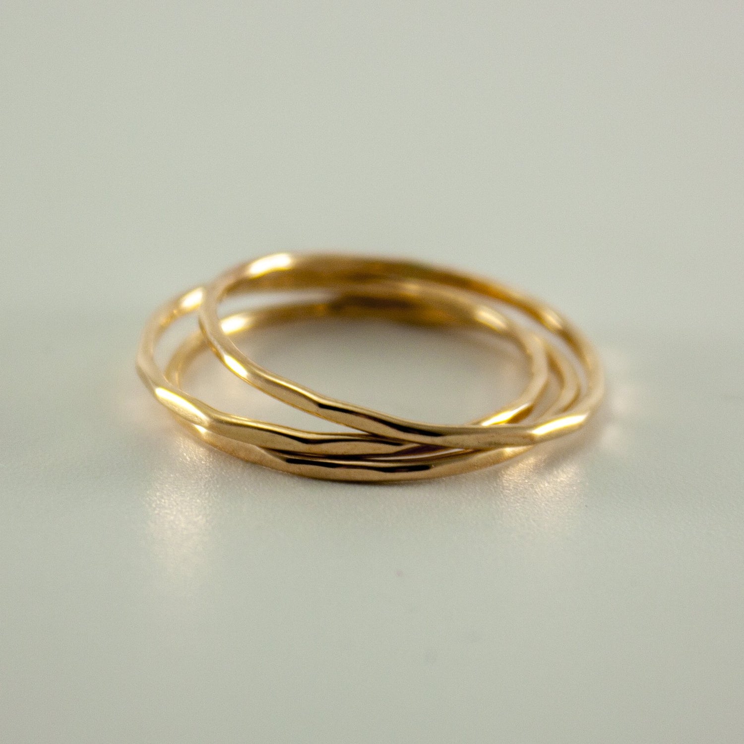 Hammered 14k gold filled slim ring stack by Grey Clymene featuring multiple stacked delicate gold bands