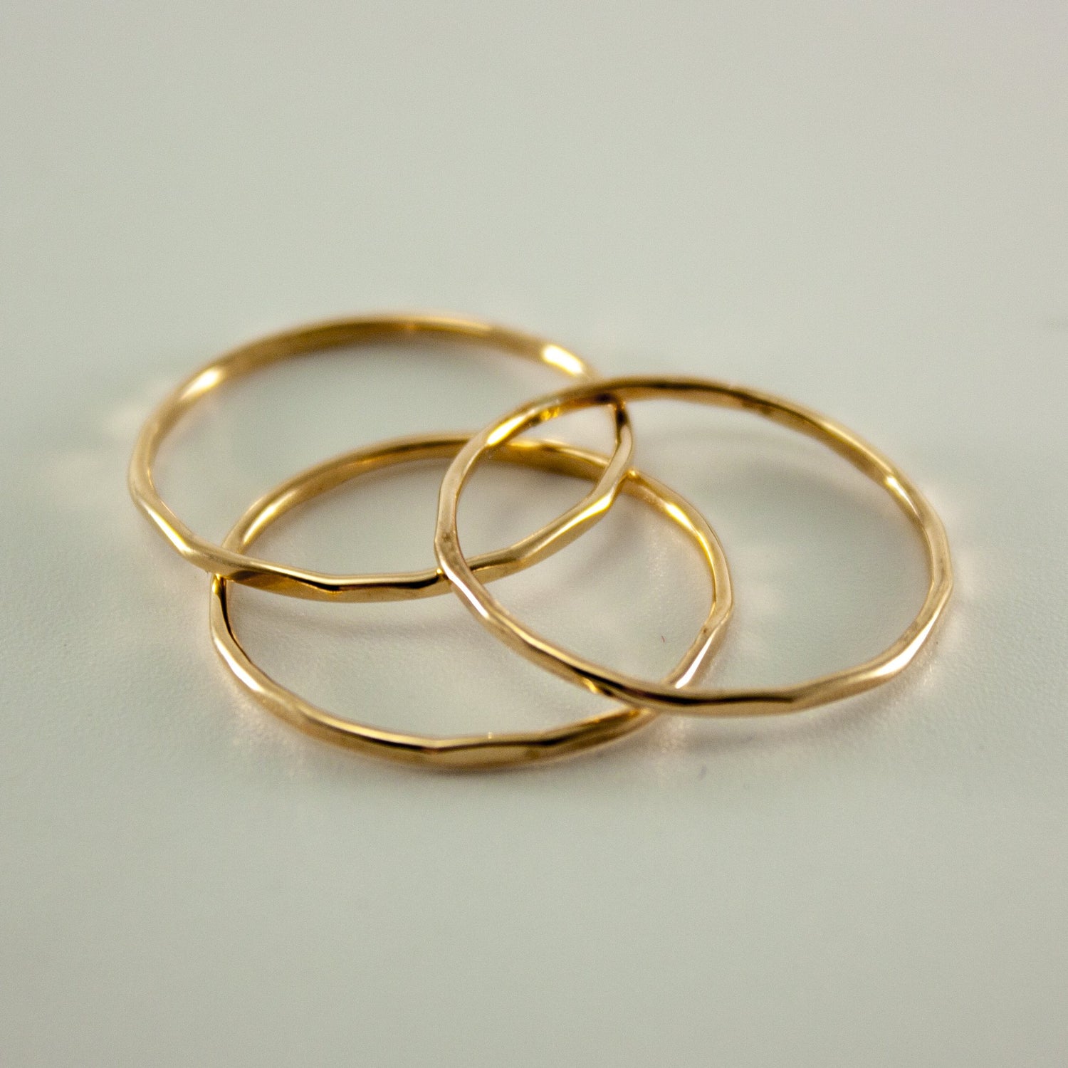 Hammered 14k gold-filled slim ring stack from Grey Clymene showcases layered minimalist jewelry design.