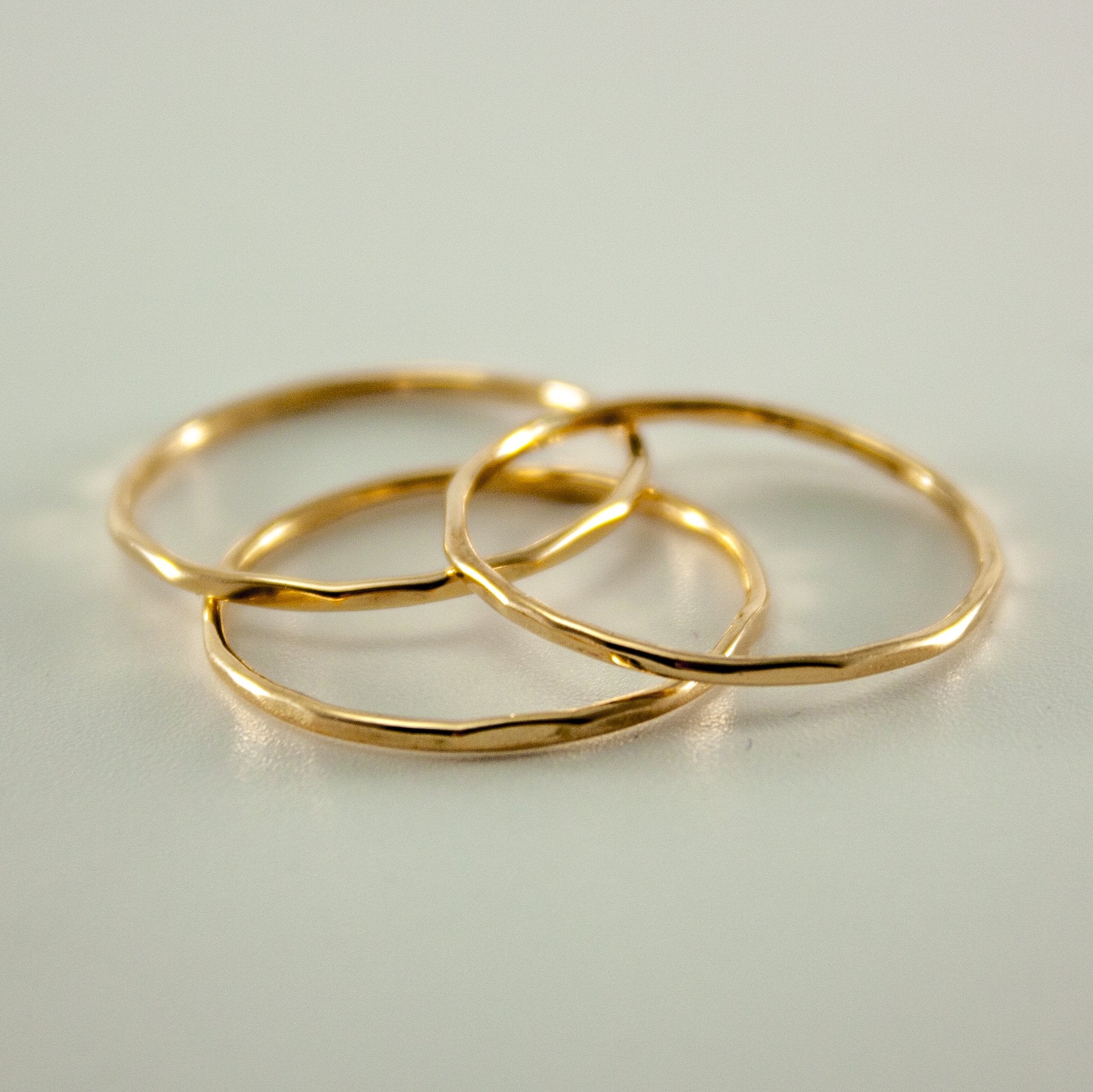 Hammered 14k gold filled slim ring stack from Grey Clymene featuring multiple delicate, textured bands for elegant jewelry styling.