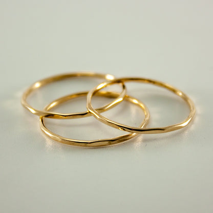 Hammered 14k gold filled slim ring stack from Grey Clymene featuring multiple delicate, textured bands for elegant jewelry styling.