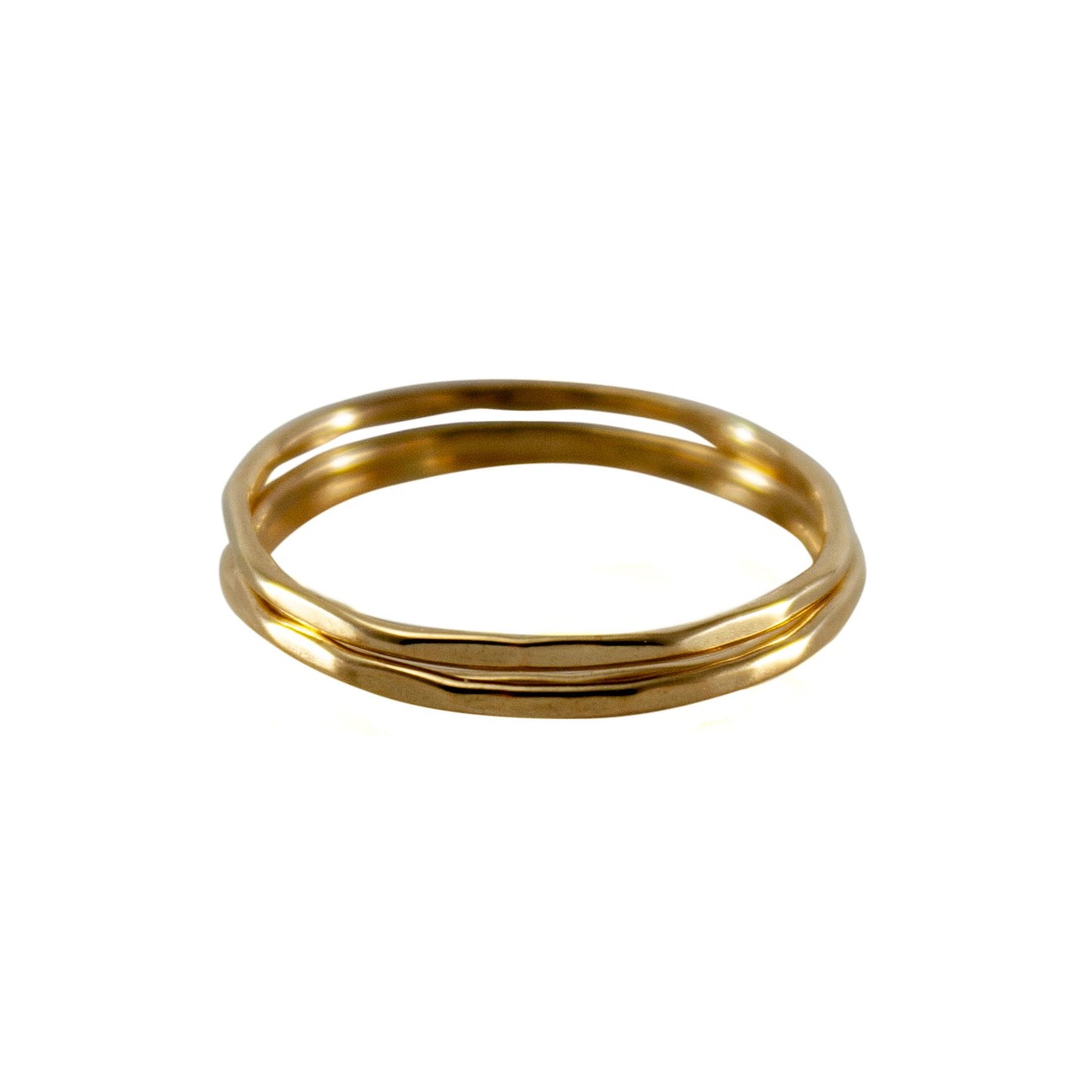 Hammered 14k gold-filled slim ring stack from Grey Clymene, featuring multiple delicate stacking rings in a sleek design.