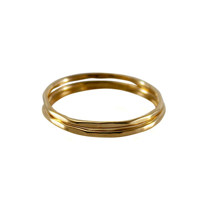Hammered 14k gold-filled slim ring stack from Grey Clymene, featuring multiple delicate stacking rings in a sleek design.