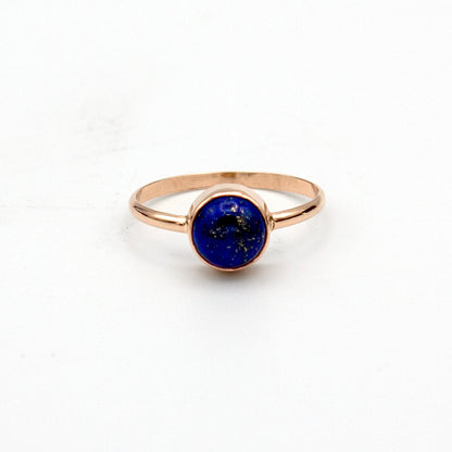 Gold-filled ring with a round bezel setting featuring a deep blue lapis lazuli gemstone, crafted by Grey Clymene.