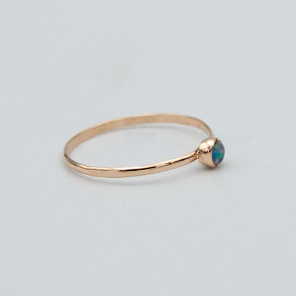 Dainty Ethiopian Opal bezel ring in 14k gold-filled jewelry, featuring a smooth oval opal gemstone setting.