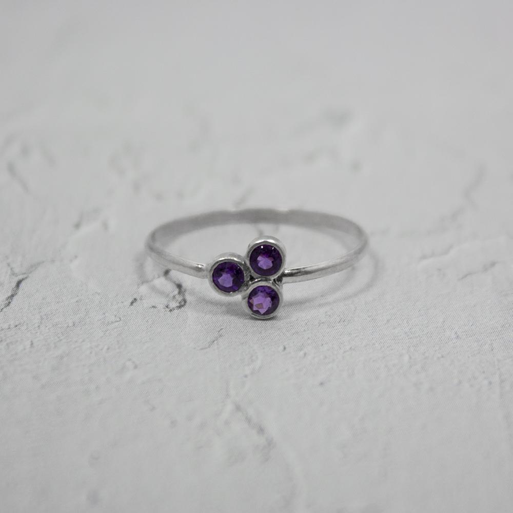 Sterling silver ring featuring a purple amethyst cluster gemstone, elegant jewelry piece with intricate silver detailing.