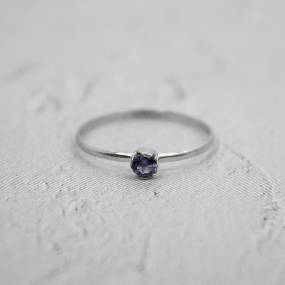Sterling silver dainty solitaire ring with a faceted iolite gemstone, designed by Grey Clymene.