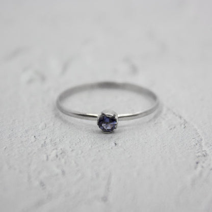 Sterling silver dainty solitaire ring with a faceted iolite gemstone, designed by Grey Clymene.